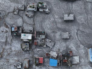 An aerial view shows debris and mud covering an area following flash floods on August 28, 2026 in DevGhat village, Nepal.