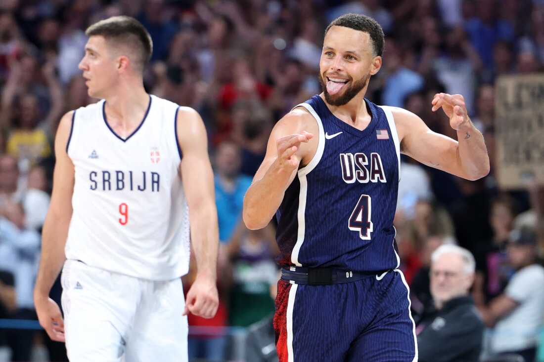 Stephen Curry reacts at the end of the USA game against Serbia. It's his first Olympics and he says he's trying to savor every minute of it.