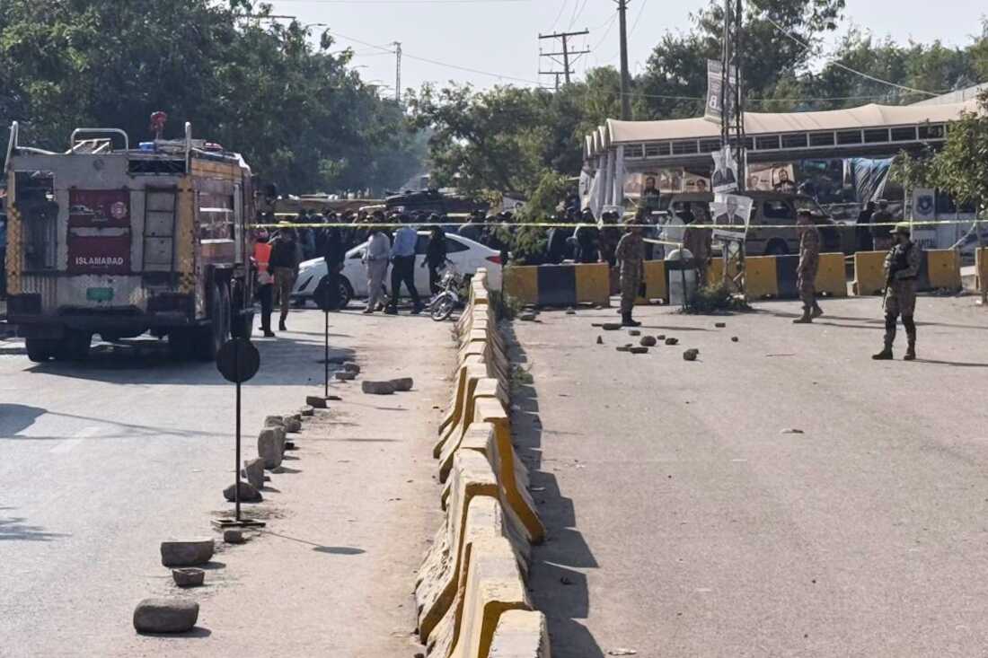 Pakistani security officials stand guard after a powerful car bomb exploded outside a district court in Islamabad, Pakistan, Tuesday, Nov. 11, 2025. (AP Photo/Mohammad Yousuf)