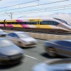 A rendering of a Brightline West surrounded by vehicles traffic Interstate 15.
