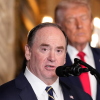 Secretary of the Navy John Phelan speaks, as President Trump listens, at Trump's Mar-a-Lago club on Dec. 22 in Palm Beach, Fla.