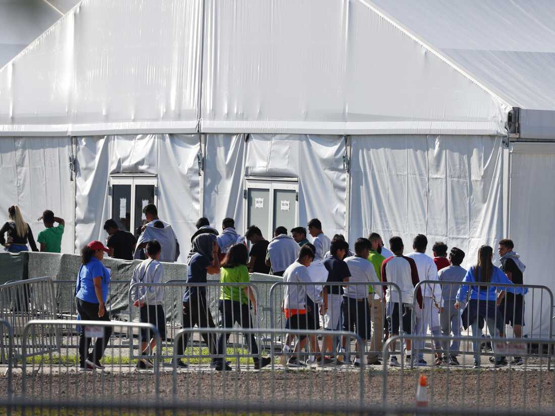 Migrant children line up to enter a tent at the Homestead Temporary Shelter for Unaccompanied Children in Homestead, Fla. in February 2019.