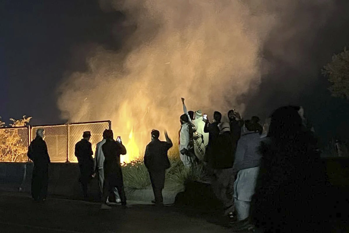 Supporters of imprisoned former premier Imran Khan's Pakistan Tehreek-e-Insaf party, burn bushes to reduce the impact of tear gas shells fired by police officers to disperse them during a rally demanding Khan's release, at a motorway in Ghazi in Attock district, Pakistan on Sunday.