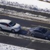 Stranded motorists in two vehicles, a four-door sedan and an SUV, wait for a tow on Interstate 95 in 2022 in Ladysmith, Virginia. Snow and ice cover portions of the highway.