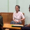 In this undated photo provided on April 30, 2026, by the Myanmar Military True News Information Team, the country's former leader Aung San Suu Kyi, center, talks with officials in an undisclosed location in Myanmar.