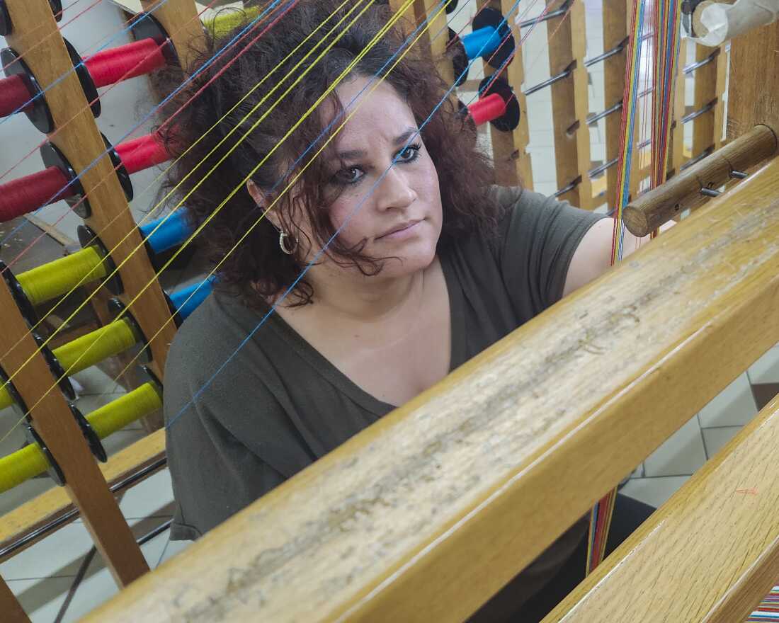 Liliana Moretti, 28, works on a loom in one of San Patrignano's textile workshops. She said the structured work schedule and sense of community in the Italian community helps people like herself heal with addiction. "This place has humanity, it has compassion," she said.