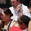 People cool themselves with an ice-cold water bottle from a water station during the Great American State Fair on the National Mall on July 2, 2026 in Washington, DC.