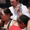 People cool themselves with an ice-cold water bottle from a water station during the Great American State Fair on the National Mall on July 2, 2026 in Washington, DC.