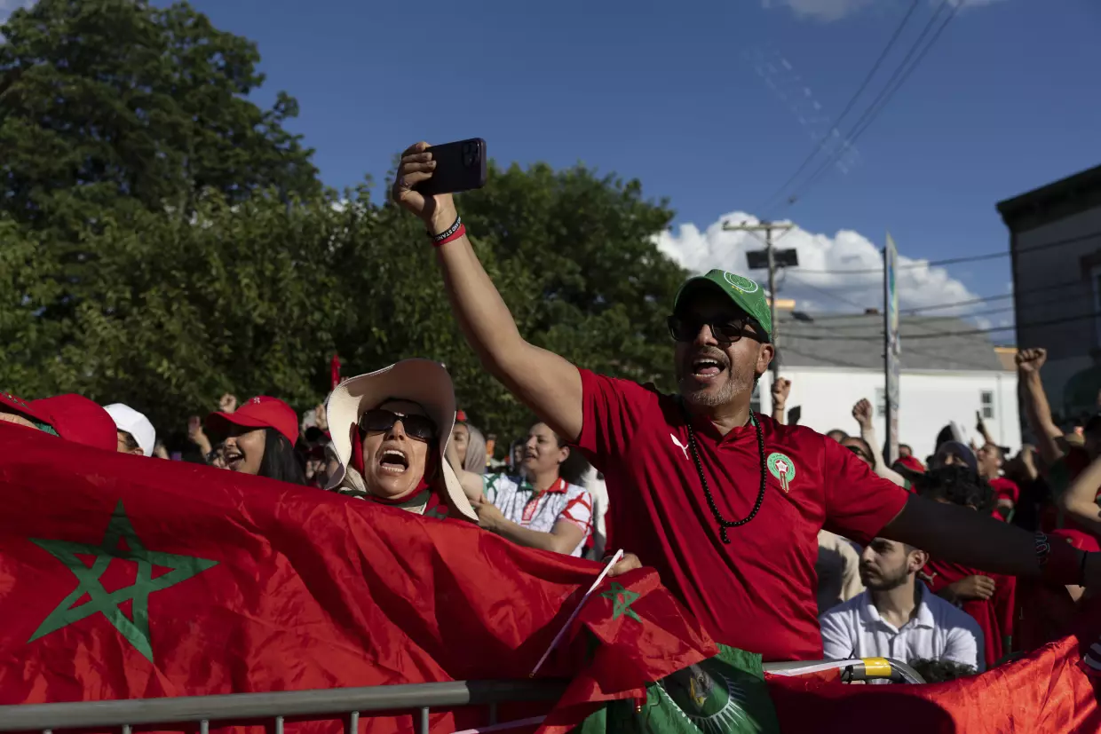 Supporters of Morocco wave flags and cheer during a watch party for the FIFA World Cup match against Brazil in Paterson, N.J. on June 13.