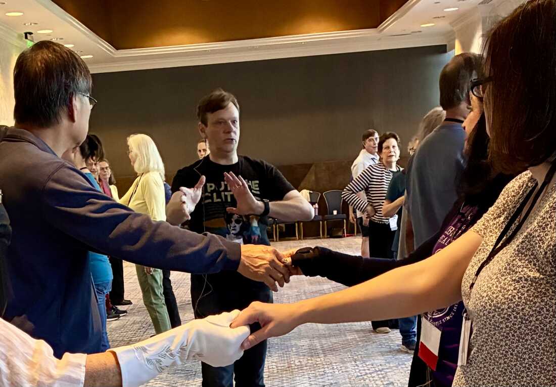 Tom Tumbusch explains 19th century dance moves to JASNA members.