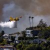 A Super Scooper plane drops water on the Palisades fire on Jan. 7 in Pacific Palisades, Calif.