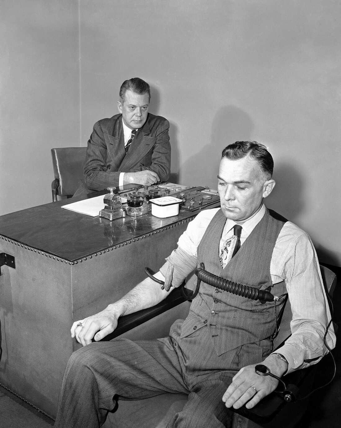 Leonarde Keeler, 48, who helped develop the science of lie detection, conducts a polygraph test on April 13, 1948. (AP Photo/Edward Kitch)