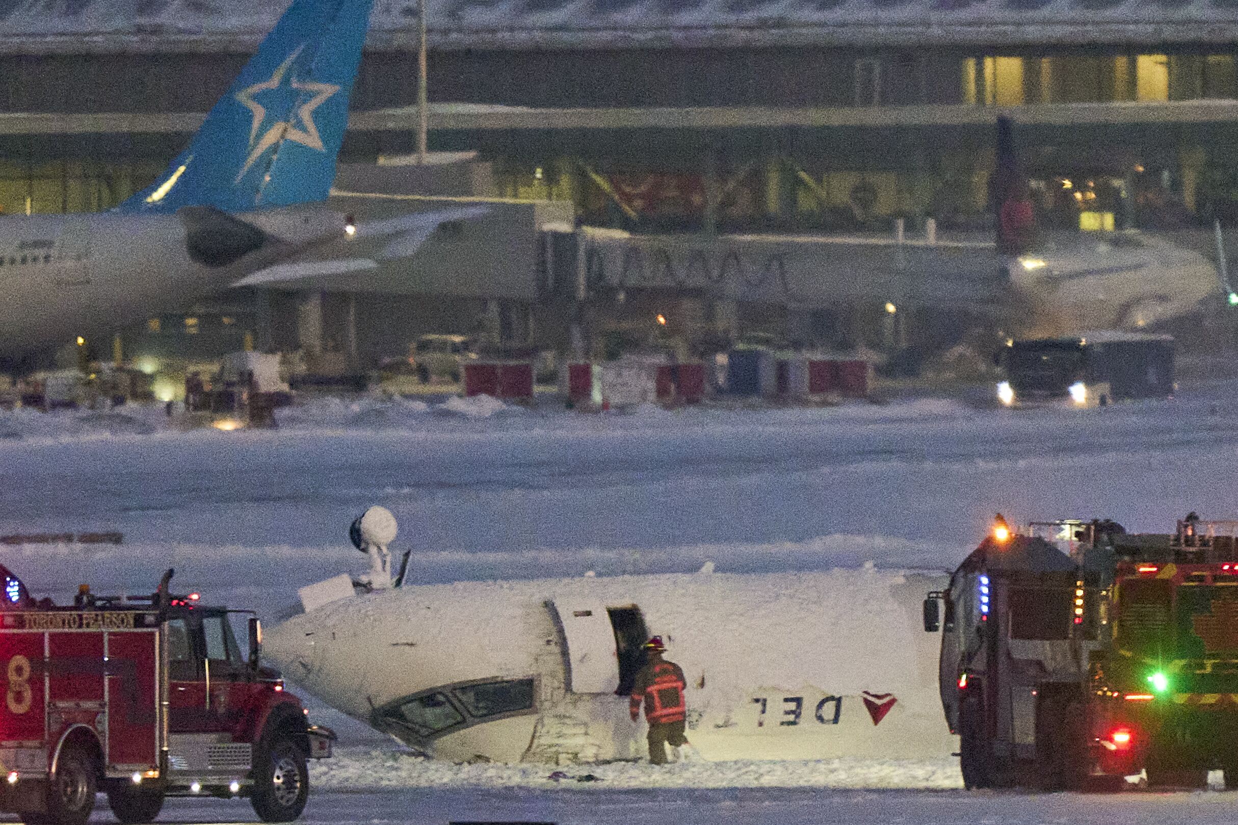 A Delta air Lines plane sits on its roof after crashing upon landing at Toronto Pearson Airport in Toronto, Ontario, on Feb. 17, 2025.