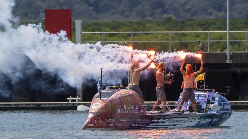 Scottish brothers, Ewan, Jamie and Lachlan, Maclean react after completing their record-breaking row from Peru across the Pacific Ocean to Cairns, Australia, on Saturday