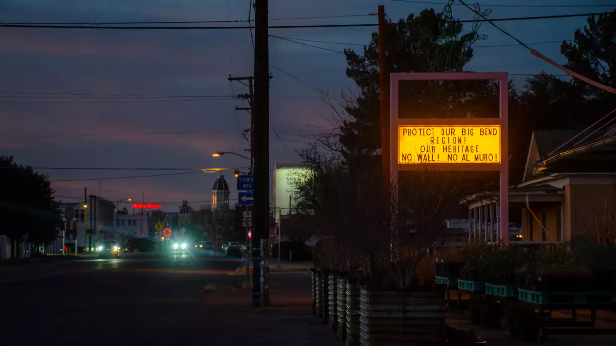 Across the Big Bend, anti-wall signs, flyers and messages have popped up in homes and businesses, like this liquor store in Marfa, Texas.