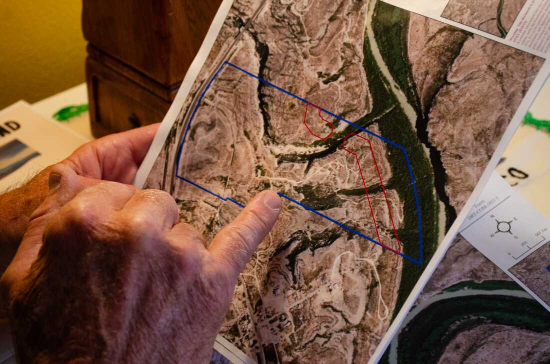 Raymond Skiles holds the letter with a map he received from U.S. Customs and Border Protection earlier this year. It shows the proposed path the border wall would take through his family land in Langtry, Texas.