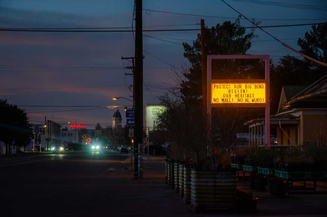 Across the Big Bend, anti-wall signs, flyers and messages have popped up in homes and businesses, like this liquor store in Marfa, Texas.
