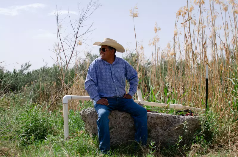 Joe Pineda, 52, sits by the banks of the Rio Grande. He pulls in water from the river to grow alfalfa, pecan trees and other crops. He also runs cattle on his family land, but he says he isn’t doing that this year because he’s worried about the wall.