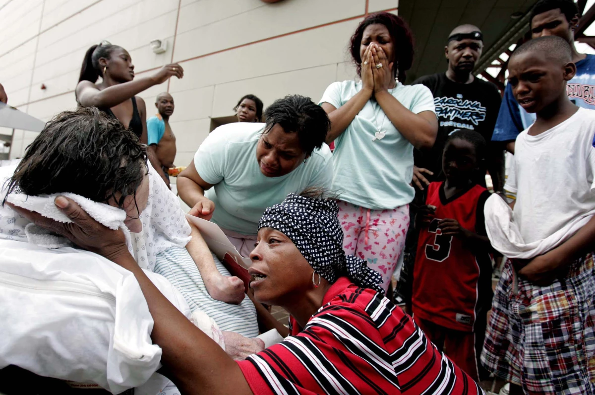 Terri Jones tries to cool fellow Hurricane Katrina flood victim Dorthy Divic, 89, who was overheated and exhausted at the Convention Center on Sept. 1, 2005 in New Orleans.