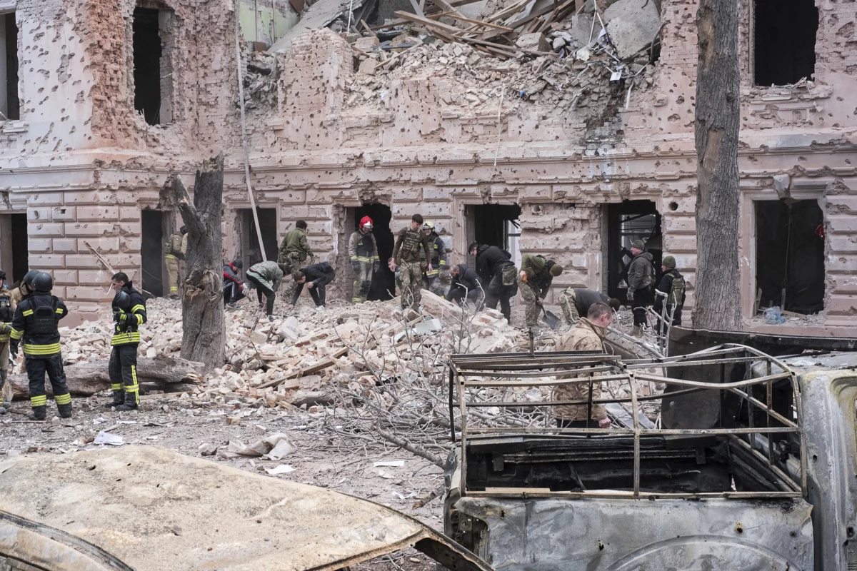 Rescue workers clear the rubble of a building hit by a Russian missile strike on Sumy, Ukraine on April 13.
