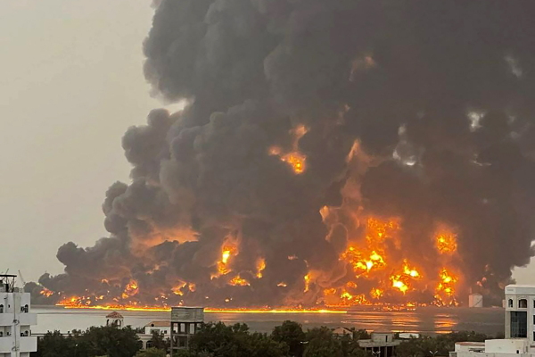 A handout picture obtained from Yemen's Huthi Ansarullah Media Center show a huge column of fire erupting following reported strikes by Israeli fighter jets in the Yemeni rebel-held port city of Hodeidah on Saturday.