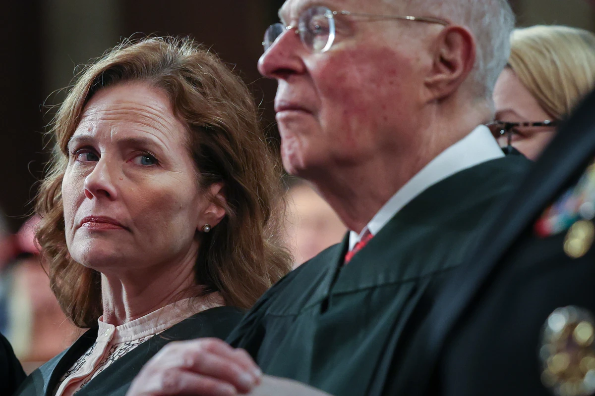 Supreme Court Justice Amy Coney Barrett and retired Supreme Court Justice Anthony Kennedy listen as President Trump addresses a joint session of Congress at the U.S. Capitol on March 4.