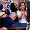 President Trump bangs a gavel after signing the "One, Big Beautiful Bill" Act into law during an Independence Day military family picnic on the South Lawn of the White House on Friday.