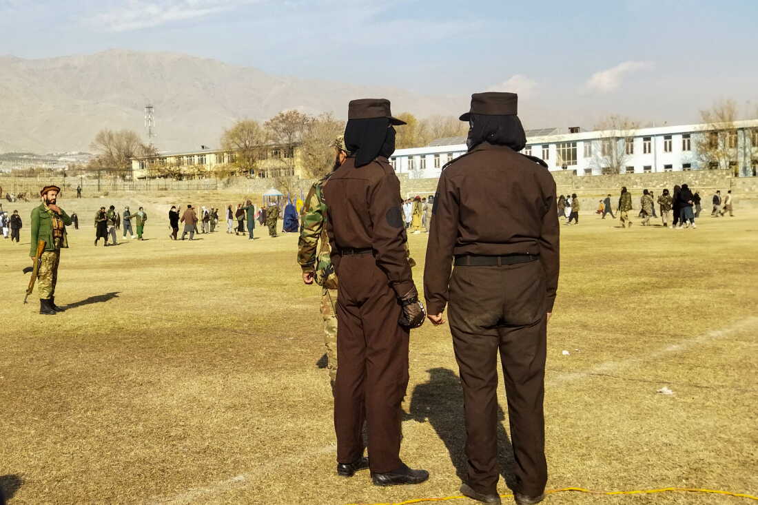 Taliban security personnel stand guard ahead of a public flogging of 27 women and men at a football stadium in Charikar city of Parwan province on December 8, 2022 in front of a large crowd.