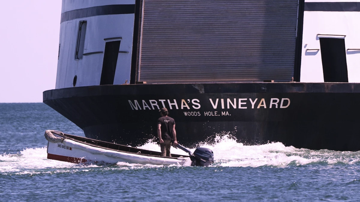 A man navigates the wake behind the Martha's Vineyard Ferry on Monday in Vineyard Haven, Mass.