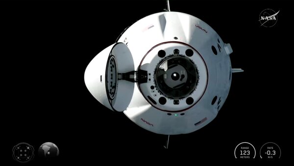 In this image from a video provided by NASA, a SpaceX Dragon capsule approaches the International Space Station for docking on Feb. 14.