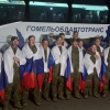 In this photo taken from video distributed by Russian Defense Ministry Press Service on Wednesday, Russian servicemen pose with national flags at an exchange area in Belarus after returning from captivity during a POWs exchange of a group of servicemen between Russia and Ukraine.