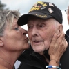 World War II veteran Gene Kleindl, age 102, from Rockford, Ill., receives a kiss from Chantell Boivin while leaving the Normandy American Cemetery on June 4 in Colleville-sur-Mer, France. Kleindl, a medic in the U.S. Army's 90th Infantry Division, arrived on the beaches of Normandy on D-Day.
