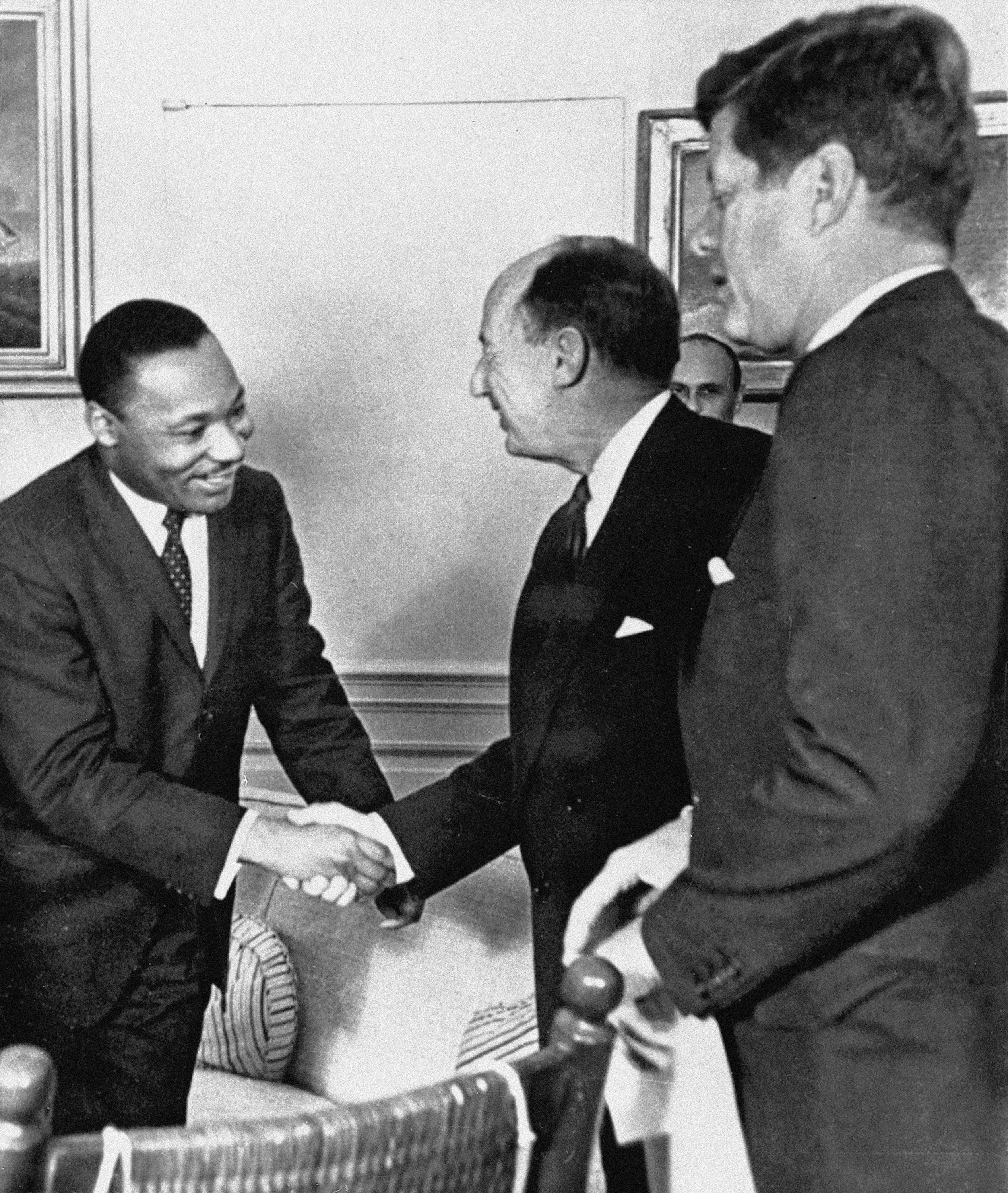 In this Dec. 17, 1962, photo, Ambassador Adlai Stevenson, the U.S. delegate to the United Nations, shakes hands with Martin Luther King Jr., president of the Southern Christian Leadership Conference at the White House with President John F. Kennedy at right. The meeting occurred as Kennedy met with members of the American Negro Leadership Conference on Africa.