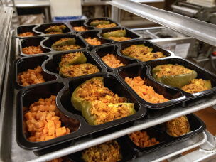 Trays of stuffed peppers and carrots from Community Servings are ready to be sealed and delivered to Boston-area residents who receive medically tailored meals.