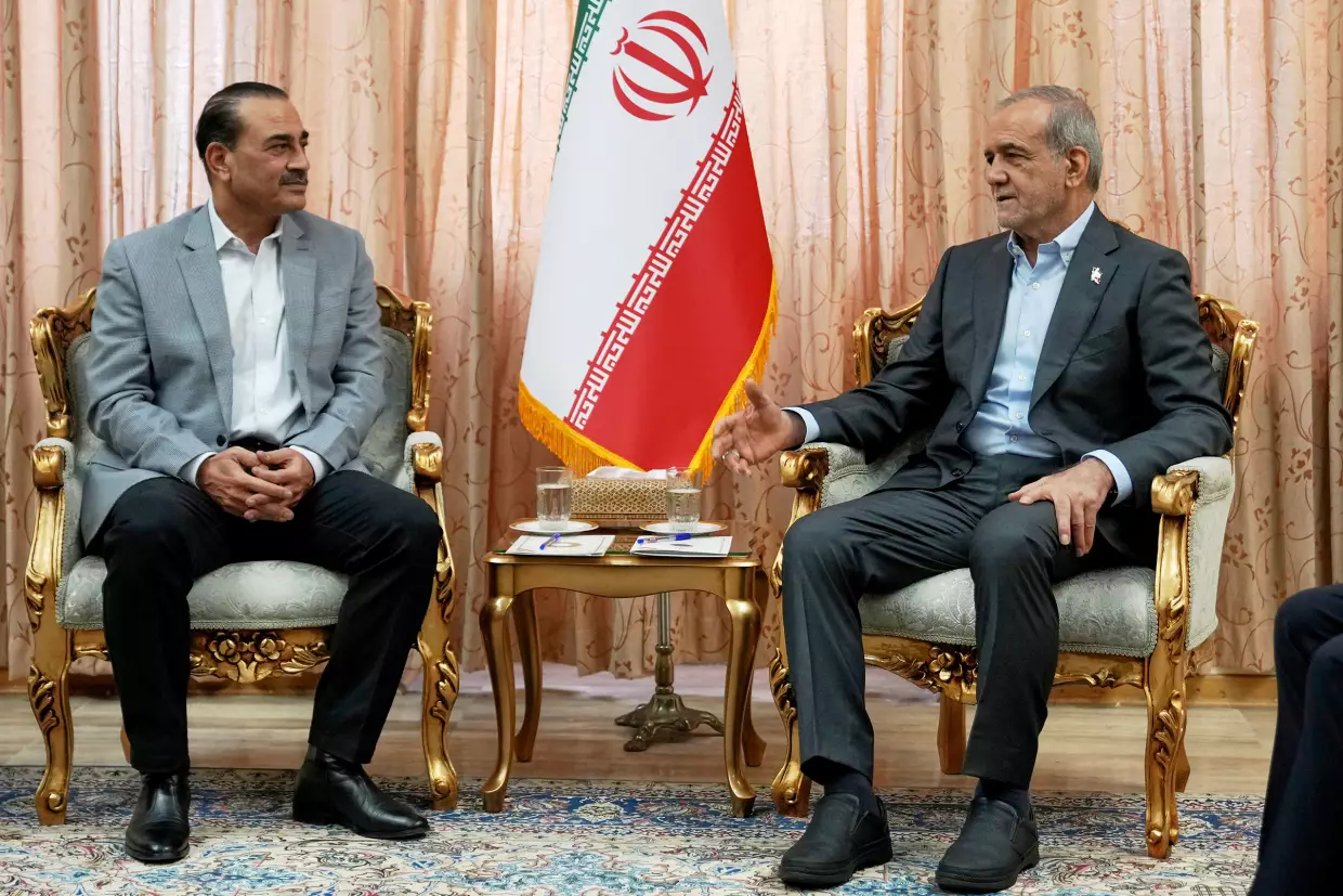 In this photo released by the Iranian Presidency Office, President Masoud Pezeshkian, right, speaks with Pakistan's Army Chief Field Marshal Gen. Asim Munir in Tehran, Iran, Saturday, May 23, 2026.