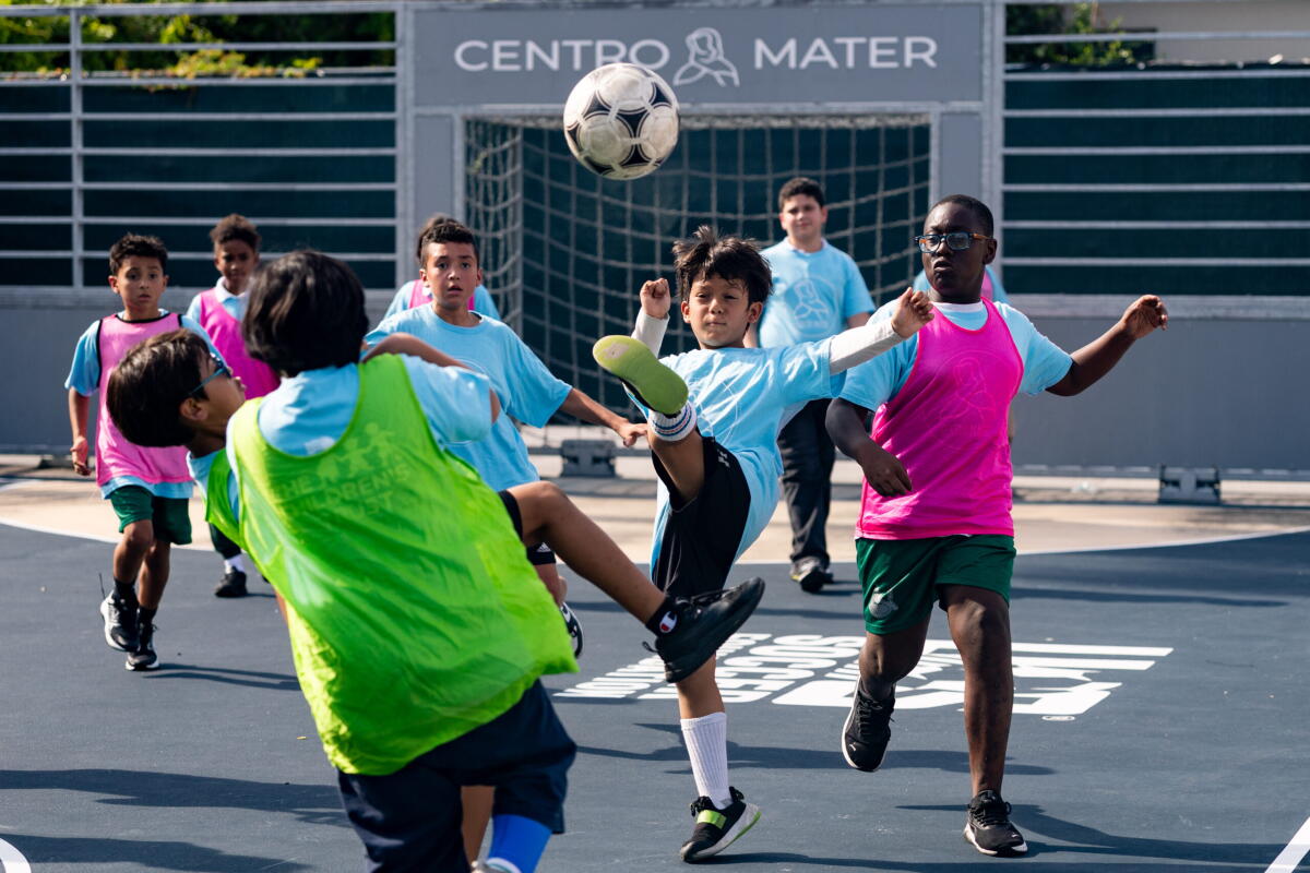 Children playing soccer on a recently opened mini-pitch at the Centro Mater early learning center in Little Havana in Miami.