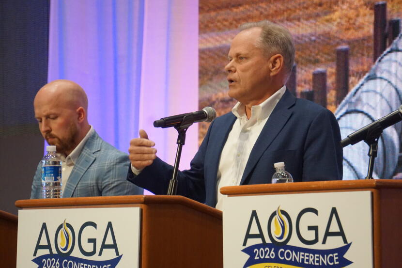 Former Anchorage Mayor Dave Bronson, a Republican who finished fourth in the open primary election, speaks at a gubernatorial candidate forum held on Aug. 26, 2026, by the Alaska Oil and Gas Association. Next to him is former state lawmaker Jonathan Kreiss-Tompkins, a Democratic candidate who received the most votes in the open primary.