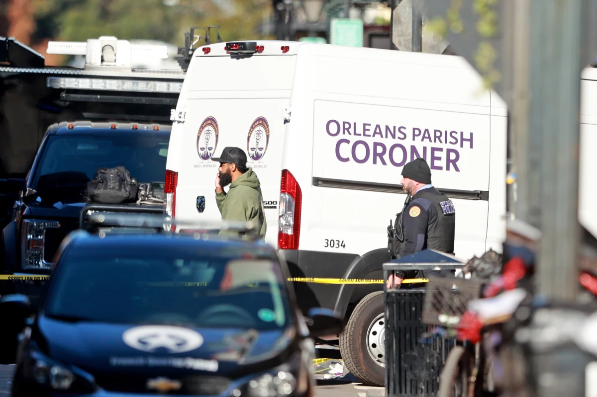 The Orleans Parish Coroner van returns to the scene on Bourbon Street after at least ten people were killed when a person allegedly drove into the crowd.