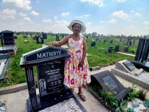Paulina Mathinye stands at her father's graveside at a cemetery in Sharpeville, South Africa, on 23 September, 2026.