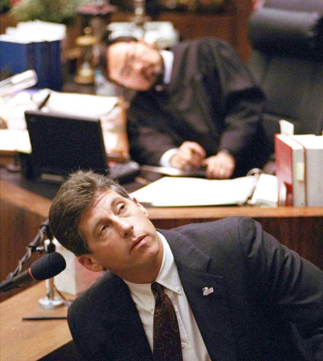FILE - Los Angeles Police Department Det. Mark Fuhrman, foreground, and Superior Court Judge Lance Ito, rear, crane their heads to look at an overhead monitor during the O.J. Simpson double-murder trial, Friday, March 10, 1995, in Los Angeles.