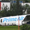 Officials investigate a Prime Air cargo plane at Miami International Airport after it overran the runway at Miami International Airport in Miami, Florida, on Sept. 6, 2026. An Amazon cargo plane overshot a runway as it landed in Miami, crashing into vehicles and catching fire, officials said.
