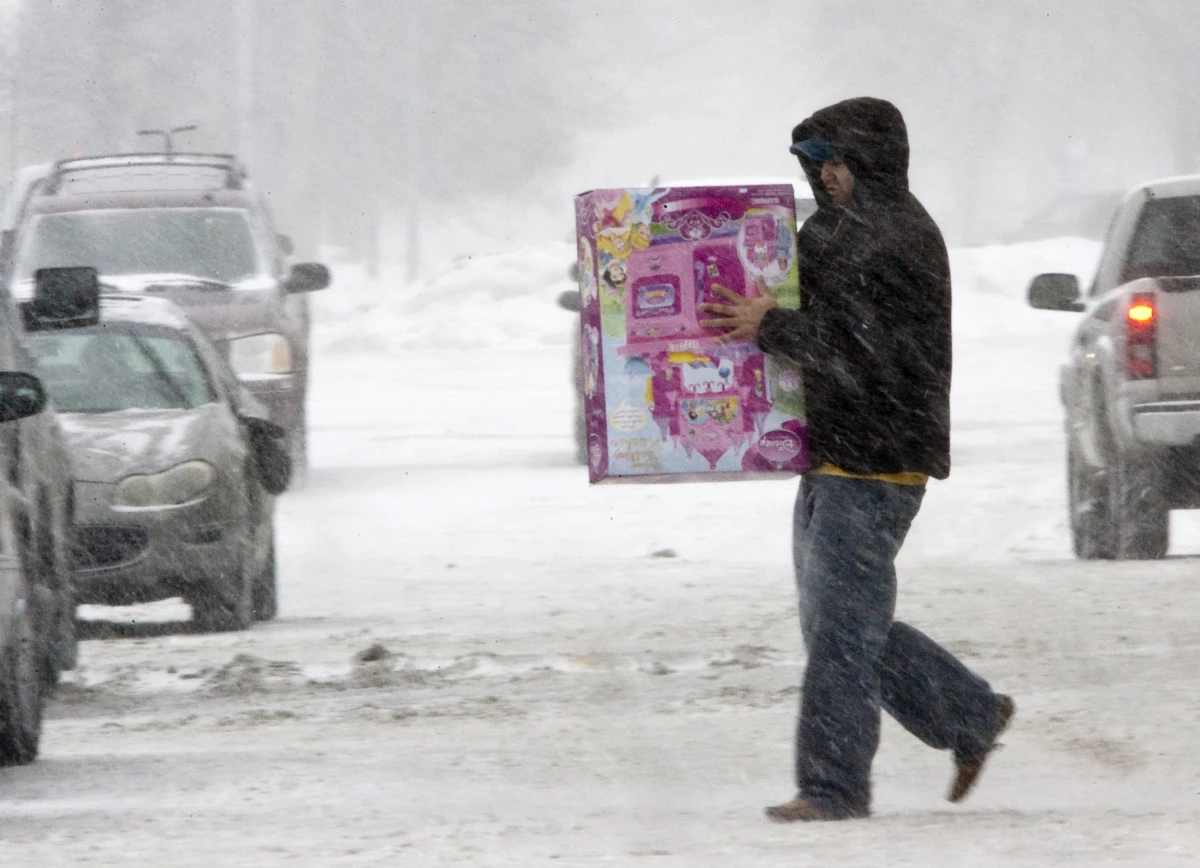 An unidentified person braves the weather to do last-minute shopping on Christmas Eve in Omaha, Neb., on Dec. 24, 2009. That year, a powerful storm spread snow, sleet and rain across the nation's midsection.