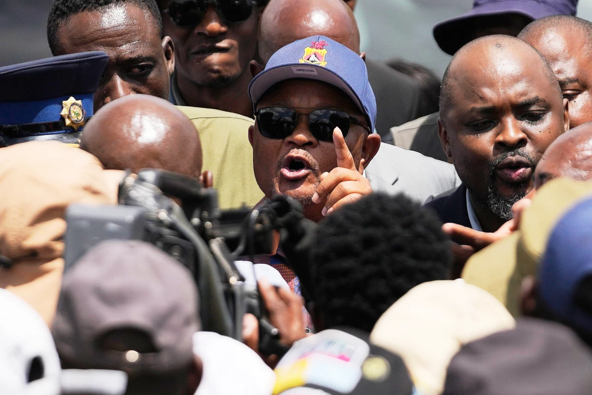 FILE - South Africa's Police Minister Senzo Mchunu, center, visits an abandoned gold mine where miners are rescued from below ground, in Stilfontein, South Africa, Jan. 14, 2025.
