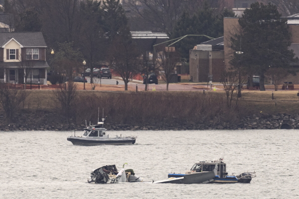 Recovery teams search the wreckage after the crash of an American Airlines plane on the Potomac River. The American Airlines flight from Wichita, Kansas collided midair with a military Black Hawk helicopter while on approach to Ronald Reagan Washington National Airport.