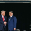 President Trump (L) and China's President Xi Jinping shake hands as they leave after their talks at the Gimhae Air Base, located next to the Gimhae International Airport in Busan in October 2025.