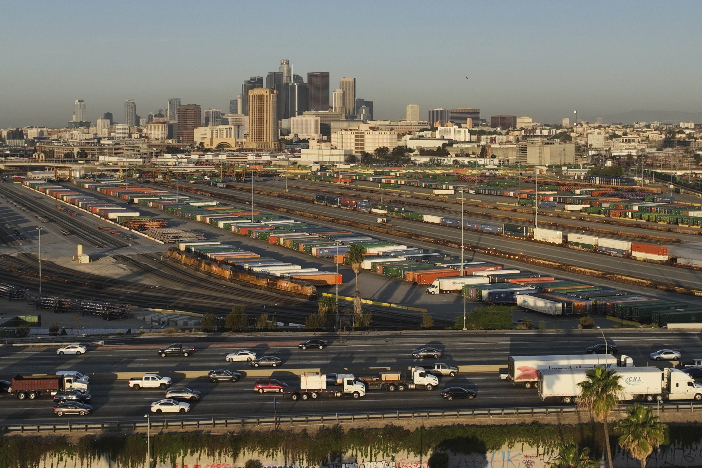 Traffic flows on Interstate 5 past shipping containers near downtown Los Angeles, Tuesday, April 8, 2025.