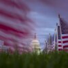American flags fly in the wind along the National Mall on Monday, with the U.S. Capitol in the background.