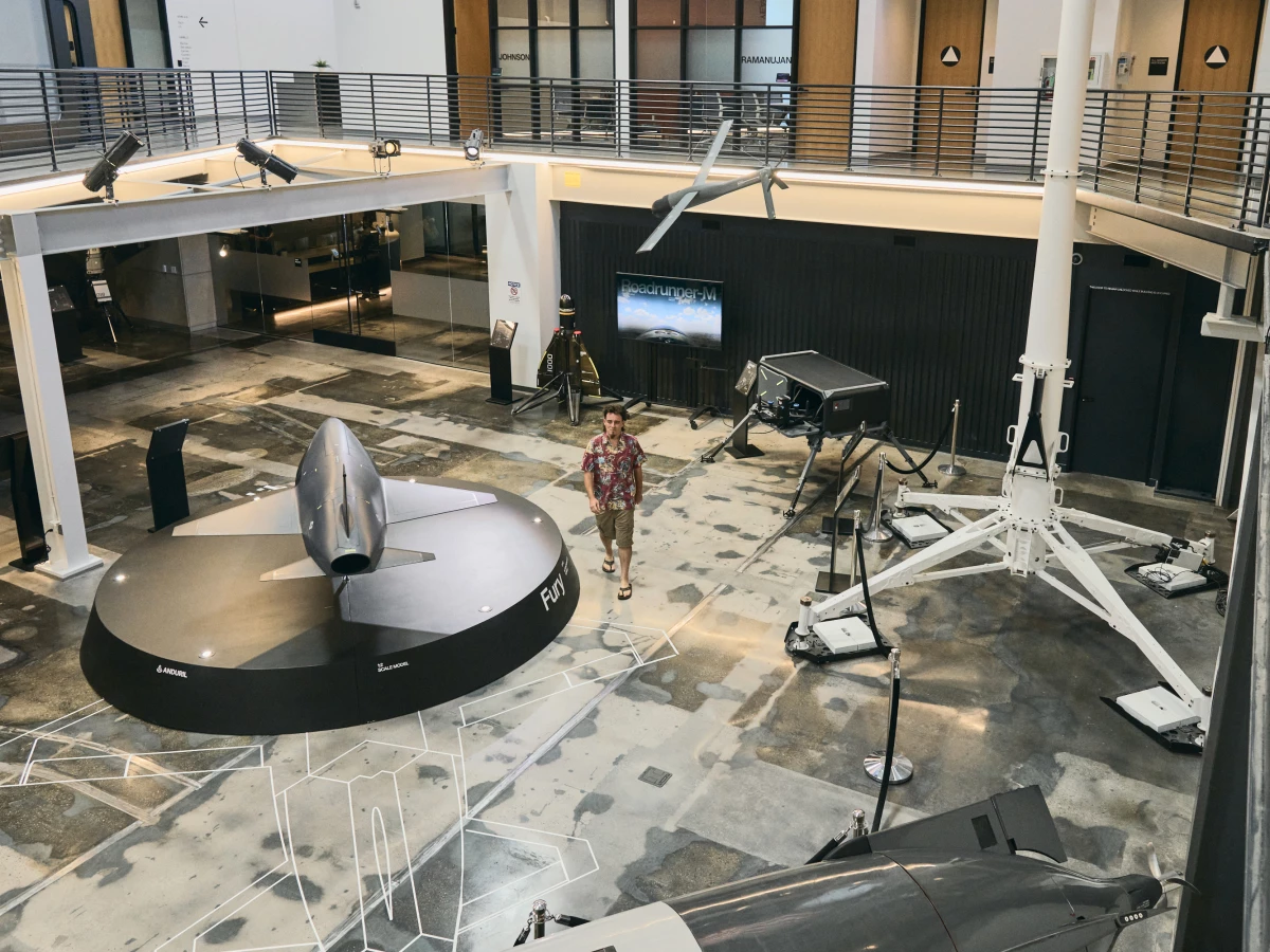 Palmer Luckey walks in the showroom featuring Anduril's artificial intelligence weapons. The company says it can build AI weapons much faster and cheaper than traditional military contractors who make large weapon systems, like fighter jets and tanks.