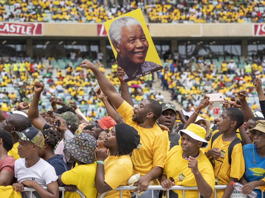 African National Congress supporters, one holding a portrait of Nelson Mandela, gather at the Mose Mabhida stadium in Durban, South Africa, Saturday, Feb. 24, 2024, for their national manifesto launch in anticipation of the 2024 general elections.