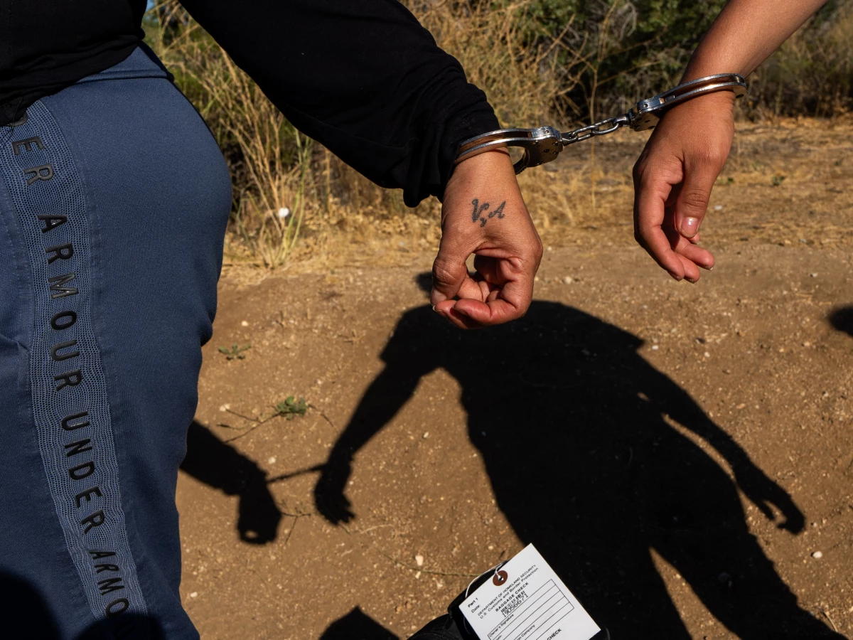Two migrants were handcuffed after an encounter with Border Patrol Agents on June 14, 2024 in Jacumba Hot Springs, California. Under newer asylum restrictions issued by the Biden administration, most migrants who cross the border with no autorization are to be denied the opportunity to request asylum.